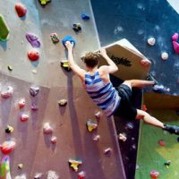 Young man on climbing wall.