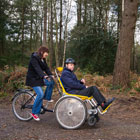 Mother and son on a tandem adapted bike.