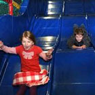 Girl and boy on blue slide.