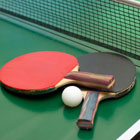 Table tennis bats and ball.